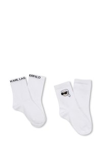 Calzini bianchi in cotone con il marchio nero "KARL LAGERFELD" e un grafico cartoon di una persona con occhiali da sole su un lato.