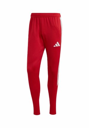 Pantalon de sport rouge en tissu extensible, avec des bandes blanches sur les côtés et le logo Adidas sur la cuisse. Taille élastique pour plus de confort.