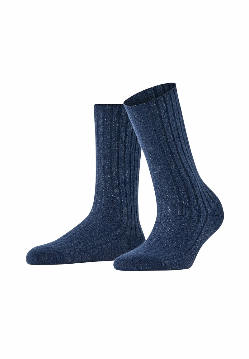 Calze a coste blu navy con una texture morbida, caratterizzate da una lunghezza standard e talloni rinforzati per una maggiore durata. Presentano un sottile dettaglio a macchie.