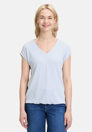Light blue short-sleeve top with a V-neck, featuring a textured fabric with small white diamond patterns and a relaxed fit.