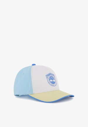 Casquette de baseball bicolore avec des panneaux bleu clair, beige et jaune, ornée d'un patch logo Timberland à l'avant.