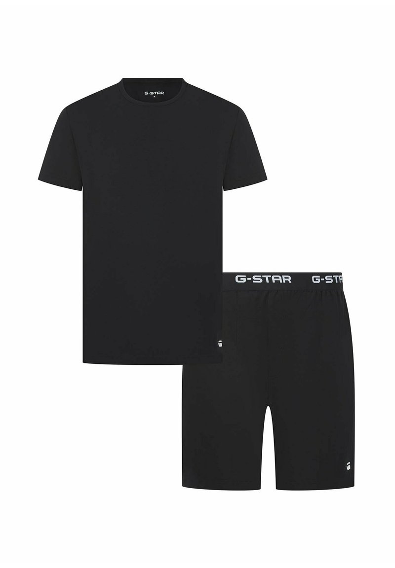 Schwarzes Baumwoll-T-Shirt mit kurzen Ärmeln und Rundhalsausschnitt, kombiniert mit schwarzen Baumwollshorts, die über einen elastischen Bund und ein Logo verfügen.