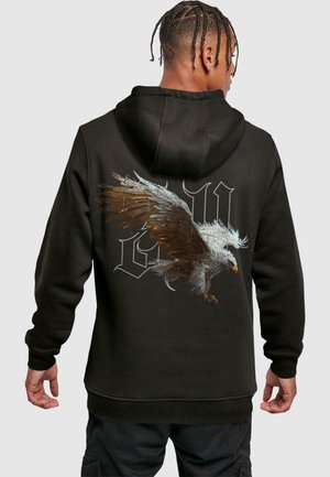 Black hooded sweatshirt with a large eagle graphic and stylized letters on the back. Features ribbed cuffs and hem. Soft fabric texture.