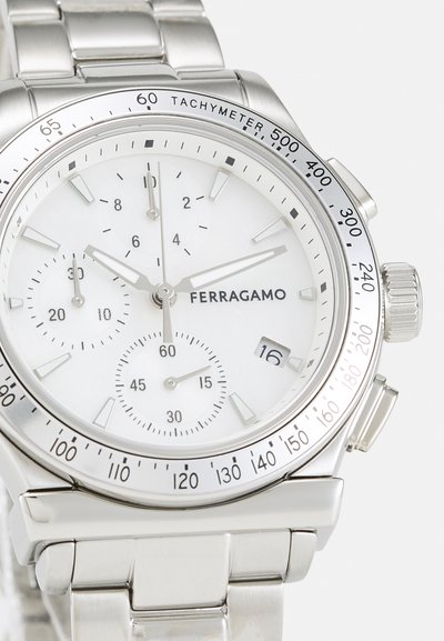 Silver stainless steel chronograph watch with a white face, black hour markers, tachymeter scale, and a date window at 4 o'clock.