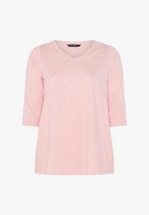 Camiseta femenina de color rosa claro, de manga corta y cuello en V, con un ajuste holgado y mangas de longitud media.