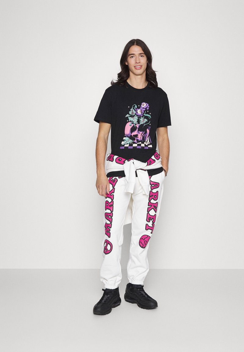 Market CALI ARC PEACE UNISEX - Calças de fato de treino - cream