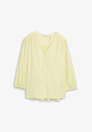 Lichtgele blouse met lange mouwen, V-hals, knopen aan de voorkant, geplooide stof bij de schouders en manchetten, en een losse pasvorm.