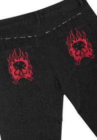 Black denim jeans with red flaming skull and crossbones embroidered on both back pockets.