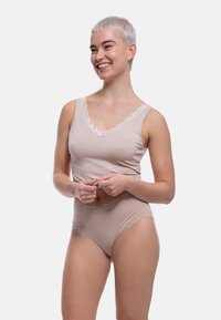 Beige camisole and matching high-waisted panties, both with delicate lace trim along the edges and soft, stretchy fabric.