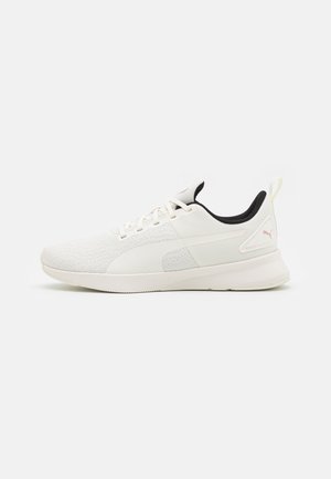Białe i jasnobeżowe niskie sneakersy z czarną wyściółką, sznurówkami, teksturowanym materiałowym czubkiem i małym logo Puma na pięcie.