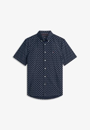Chemise à manches courtes bleu marine avec motif géométrique blanc et col à boutons, présentée à plat sur fond blanc.
