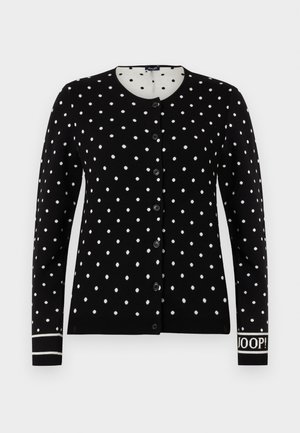 Fekete gombos kardigán fehér pöttyökkel, kerek nyakkivágással és "JOOP!" felirattal a bal mandzsettán.