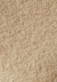 Tela de lana beige con un patrón texturizado y acanalado. Superficie suave, ligeramente difusa, con variaciones en tono y grosor.