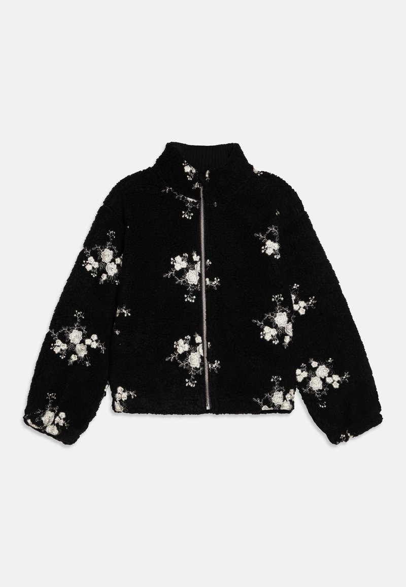 Svart fleecetröja med hög krage, dragkedja och blommönster i vitt. Har mjuk textur och lös passform, med ribbade ärmslut.