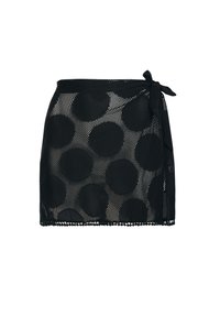 Czarna siateczkowa spódnica z dużymi okrągłymi wzorami, z wiązaniem w talii i falbaniastym wykończeniem. Lekka i półprzezroczysta konstrukcja.
