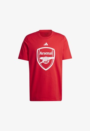 Punane puuvillane T-särk, mille keskel on valge Arsenal'i logo ja üleval adidas'i logo. Ümmargune kaelus, lühikesed varrukad, tavaline lõige.