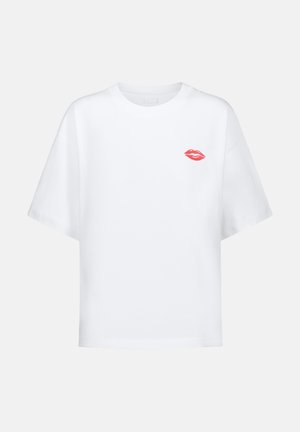 White cotton T-shirt with a relaxed fit, short sleeves, and a red lip graphic embroidered on the left chest.