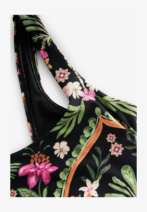 Fekete virágmintás anyag, rózsaszín és fehér virágokkal, zöld levelekkel. Simaszerű textúra és állítható pántok díszítő szegéllyel.