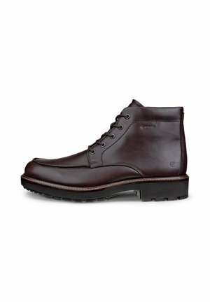 Leather ankle boots in dark brown. Features include lace-up design, rounded toe, textured side panels, and a rugged sole for grip.