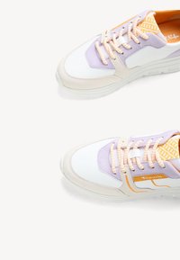 Multicolored sneakers with white, lavender, and orange accents. Features a smooth synthetic upper, round toe, and textured laces.