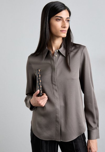 Long-sleeve, collared shirt in stone gray, made from smooth fabric. Features button accents, relaxed fit, and curved hem.