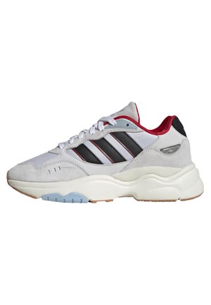 White and gray sneaker with black stripes, red inner lining, white laces, and thick white sole with light blue and gum accents.