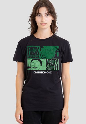 Young woman wearing a black t-shirt with green graphic squares featuring cartoon faces and text "Rick Morty Smith Dimension C-137"