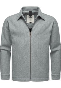 Veste zippée gris clair en tissu doux et texturé. Présente un col chemise, des manches longues et un logo discret sur l'étiquette intérieure.