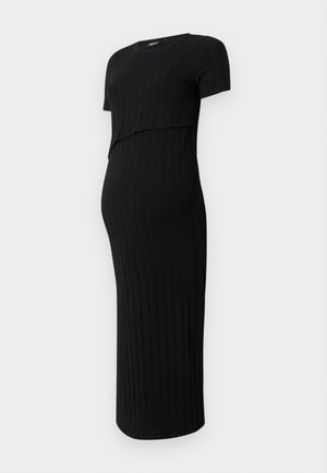 Robe de maternité noire en tissu côtelé. Présente un design ajusté avec des manches courtes et un ourlet incurvé, adapté à un ventre qui s'arrondit.
