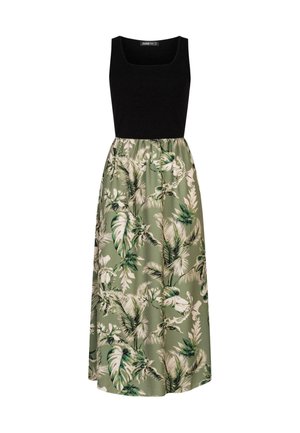 Haut sans manches noir avec un décolleté carré ; jupe fluide verte ornée d'un motif de feuilles tropicales en blanc et en tons de vert foncé.