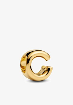Anello in oro a forma di lettera "G" con un design arrotondato e scultoreo. Texture liscia con finitura lucida, che mette in mostra un centro cavo.