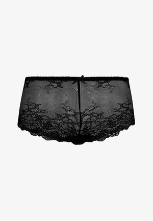 Culottes en dentelle noire avec des motifs floraux, des bords festonnés et un détail de nœud central. Tissu doux et transparent avec une finition texturée.