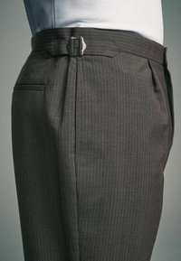Tailored gray pinstripe trousers with a slim fit, featuring a metal buckle closure, side pockets, and smooth fabric texture.