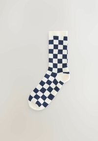 Navy en witte geruite katoenen sok met geribde manchet, met afwisselend vierkantpatronen en een gladde textuur.