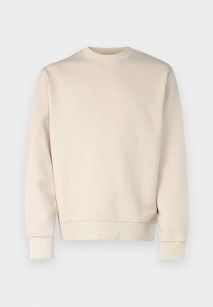 Sweat-shirt beige clair avec col rond, poignets et ourlet côtelés. Confectionné en tissu doux à la texture lisse. Design minimaliste, sans motifs.