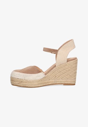 Sandalia de cuña con parte superior en tonos beige y crema, lona texturizada, y un tacón de yute trenzado con plataforma, diseño de punta cerrada y tira en el tobillo.