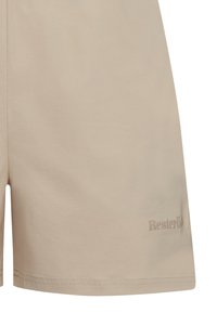 Pantalones cortos de algodón beige con corte recto, abertura lateral y un sutil detalle del logo en el dobladillo. Textura suave con costuras mínimas.