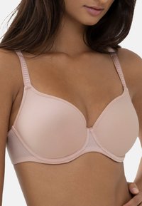 Reggiseno rosa chiaro, senza cuciture, con coppe sagomate, spalline regolabili e texture liscia. Presenta cuciture sottili e un design classico.