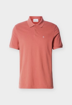 Men's short-sleeve dusty rose polo shirt with two buttons and small white "cK" logo on the left chest.