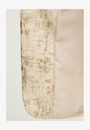 Fabric with textured gold and beige pattern on left and smooth plain beige fabric on right.