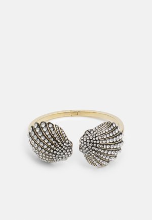 Gold-toned bracelet with two shell-shaped ends adorned with clear rhinestones, featuring a textured surface and a sleek design.