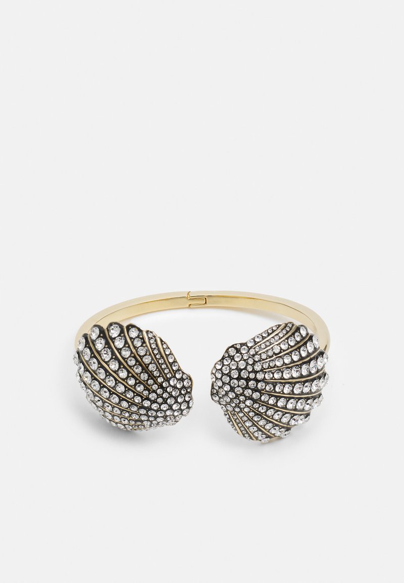 Kuldtooni käevõru, millel on kaks kestakuju otsa, mis on kaunistatud selgete rhinestone'idega, omades tekstuurset pinda ja sleek disaini.