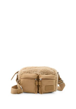 Beige Umhängetasche mit zwei vorderen Reißverschlusstaschen, verstellbarem Riemen und weichem Lammfellfutter entlang des oberen Randes.