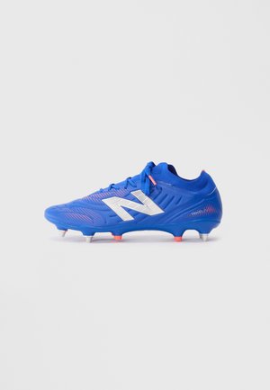 Blue soccer cleat with white logo, pink accents, laces, and metal studs on a plain gray background.