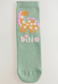 Green sock featuring a brown dinosaur with white flowers, pink accents, and the word "DINO" in white and pink at the bottom.