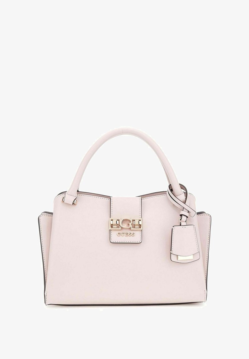 Sac à main rose clair en matériau lisse, doté d'un fermoir doré, d'un logo et d'une étiquette d'accent amovible. Forme structurée avec des poignées.