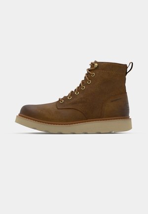 Brown waterproof ankle boot made of textured leather, featuring gold eyelets, a rounded toe, and a light, textured rubber sole.