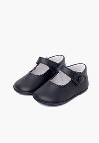 Scarpe Mary Jane in pelle nera con punta rotonda, bordo scalloppato e cinturino regolabile con bottone per una vestibilità sicura.