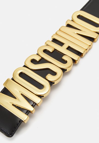 Čierny opasok s veľkými, tučnými zlatými písmenami s nápisom "MOSCHINO", so hladkým, lesklým povrchom a lesklým finišom.
