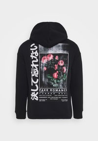 Black hoodie featuring a graphic design with pink flowers and text in white and Japanese characters on the back. Soft cotton material.